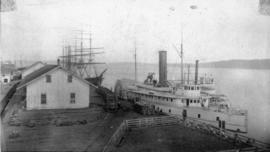View of three ships including a sidewheeler at the Northern Pacific dock, Tacoma, Washington Terr...